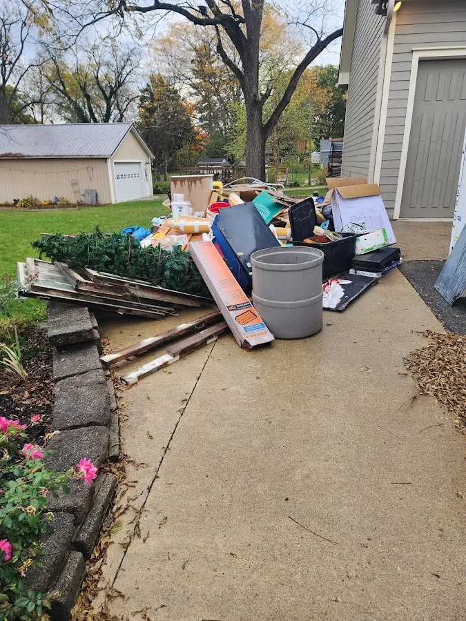 Dumpster being loaded with debris for Estate Cleanout Dumpster Rental in Havre de Grace